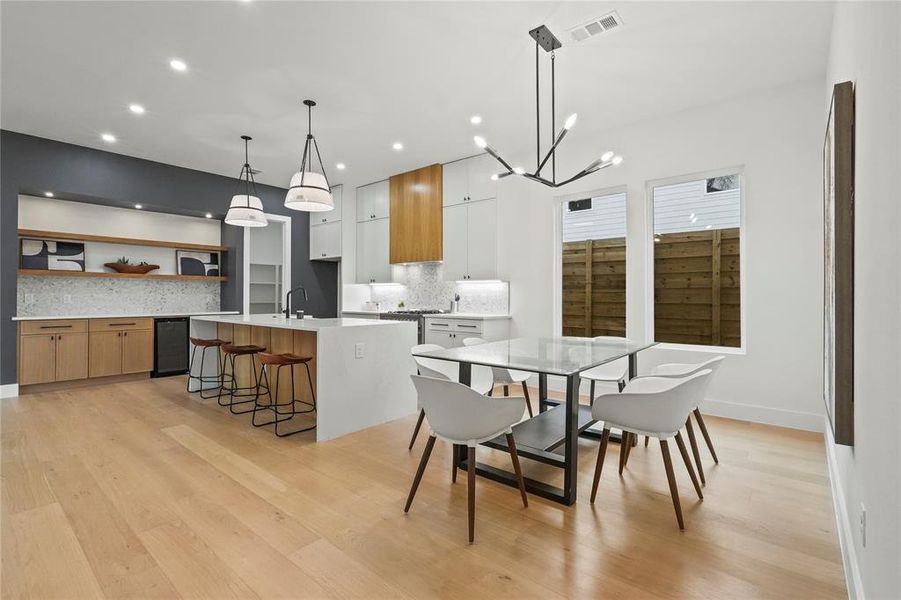 Dining space featuring light wood-type flooring and hanging lights