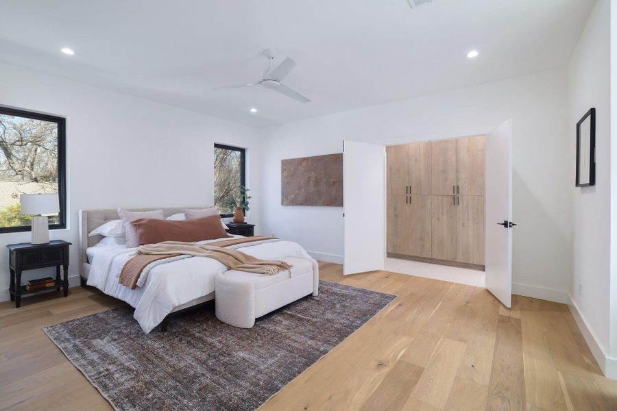 Bedroom with light wood-type flooring, ceiling fan, and recessed lighting