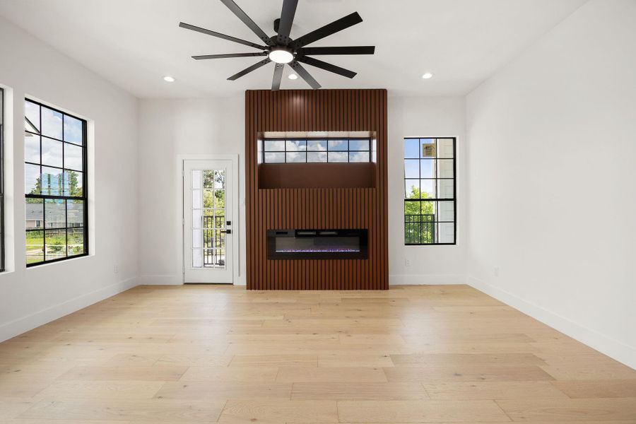 Another view from the kitchen highlights the retractable TV and electric fireplace, with convenient access to the balcony.