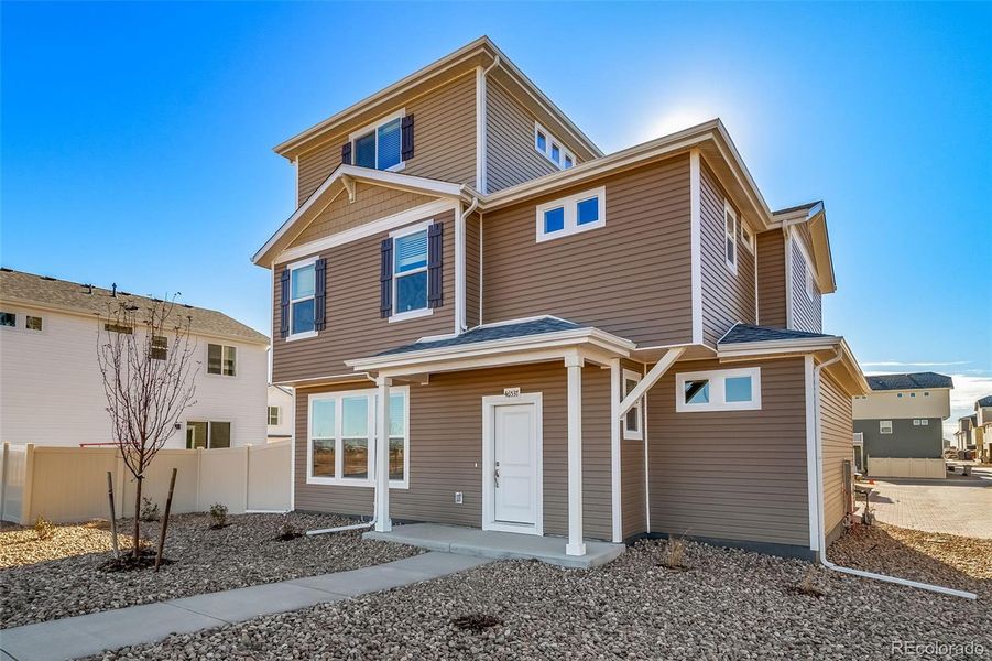 Front exterior of a new home in Muegge Farms, Bennett, CO, highlighting curb appeal (Image 1).