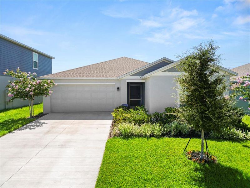 Front exterior of a new home in Hunt Club Groves, Lake Wales, FL, highlighting curb appeal (Image 2).
