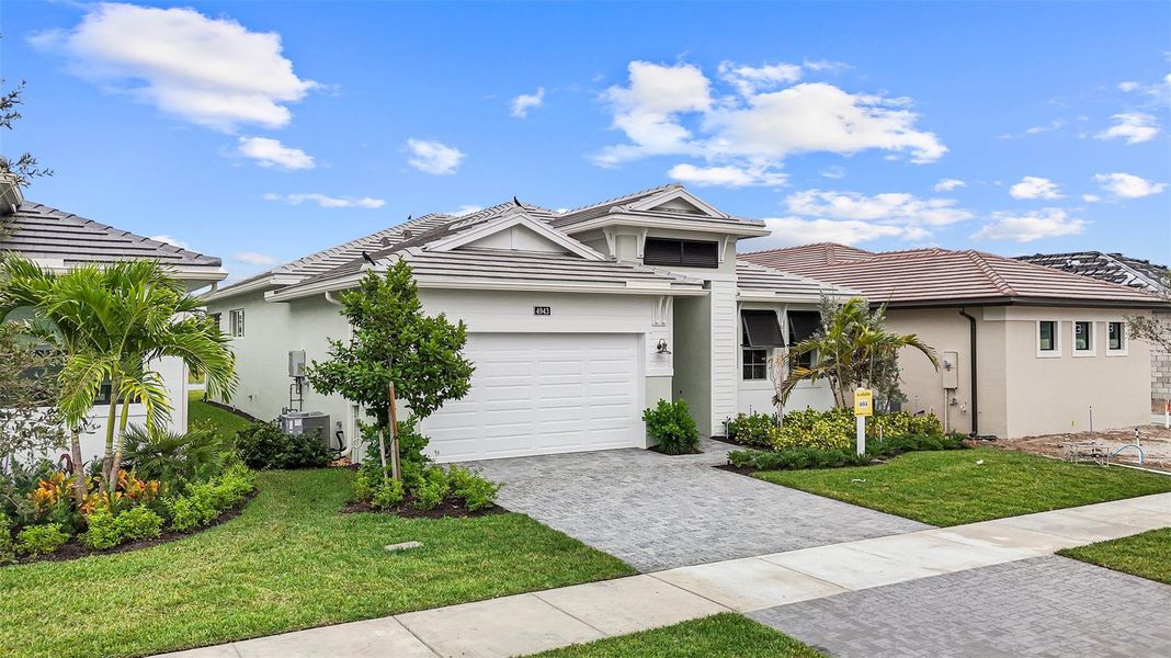 Front exterior of a new home in Cresswind Palm Beach at Westlake, Westlake, FL, highlighting curb appeal (Image 25).