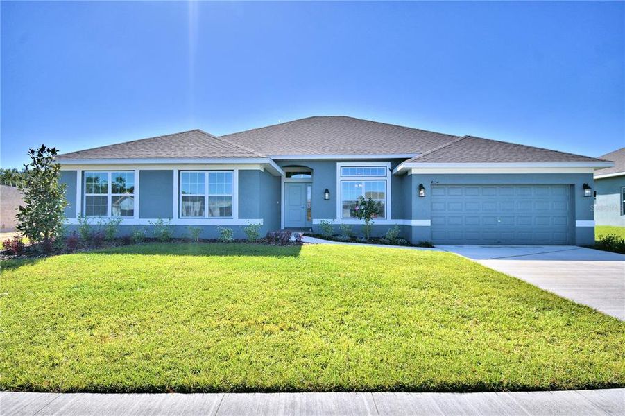 Front exterior of a new home in Cadence Crossing, Auburndale, FL, highlighting curb appeal (Image 1). Front exterior of a new home in Cadence Crossing, Auburndale, FL, highlighting curb appeal (Image 1).