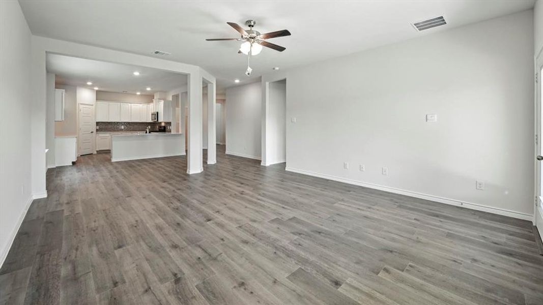 Unfurnished living room featuring recessed lighting, dark wood-style floors, and a ceiling fan Unfurnished living room featuring recessed lighting, dark wood-style floors, and a ceiling fan
