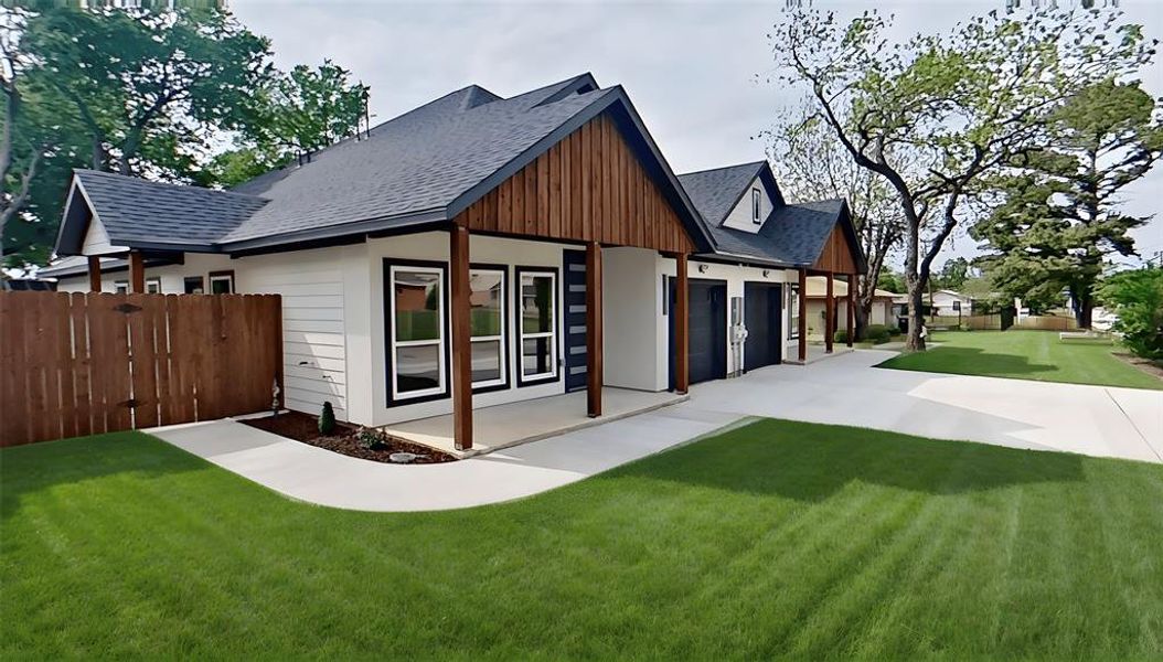 Contemporary exterior featuring white siding, dark wood accents, and a dark shingle roof