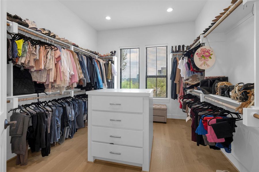 Expansive primary walk-in closet with built-in storage.