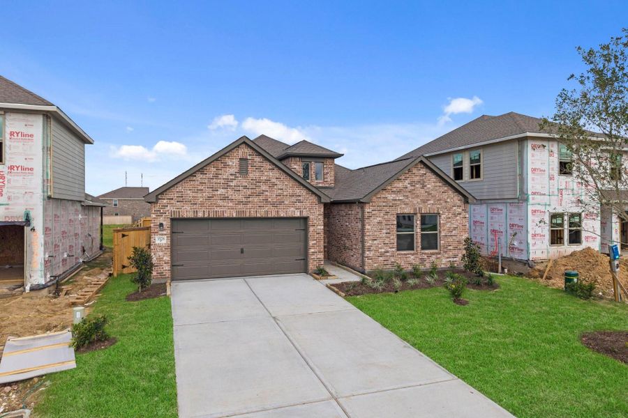 Front exterior of a new home in Windrose Green, Angleton, TX, highlighting curb appeal (Image 22).