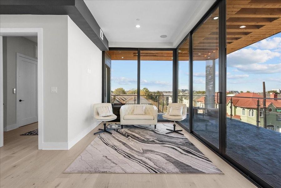 The top-level bedroom can easily function as a fourth bedroom or a full game room, featuring oversized windows that frame beautiful views and create an impressive indoor-outdoor feeling throughout.