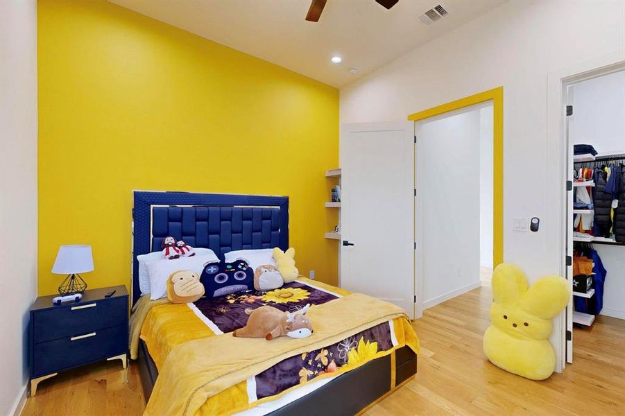 Bedroom with light wood-type flooring, lofted ceiling, a spacious closet, ceiling fan, and recessed lighting Bedroom with light wood-type flooring, lofted ceiling, a spacious closet, ceiling fan, and recessed lighting