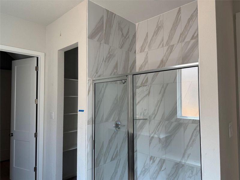 Bathroom featuring a marble finish shower Bathroom featuring a marble finish shower