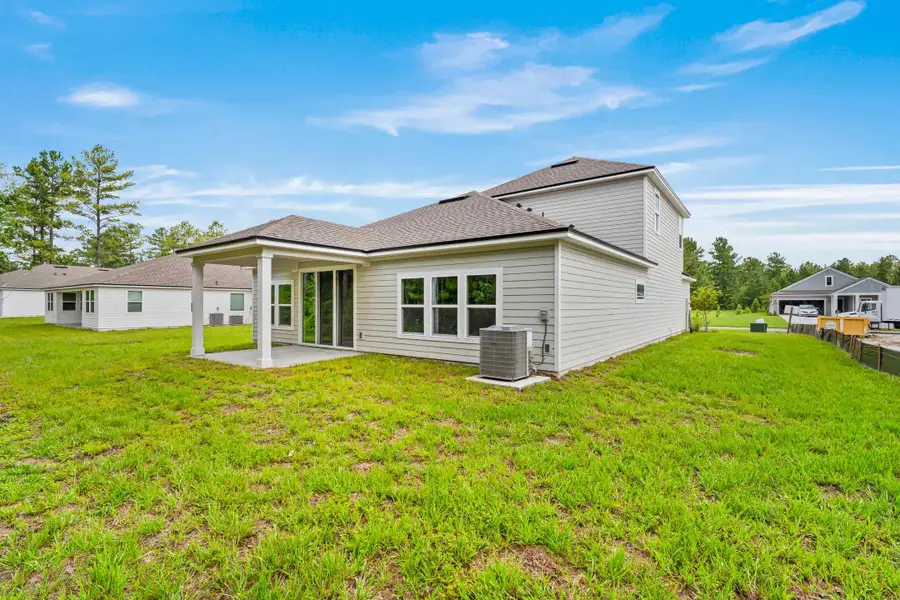 Dogwood Plan Lot 582 Rear Exterior with Covered Patio at NorthShore in Kingsland