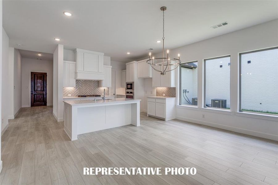 Light, bright and airy, this open concept kitchen-dining-family room is everything you have been searching for!  REPRESENTATIVE PHOTO