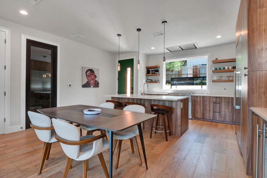 Dining area featuring light wood-style flooring and recessed lighting