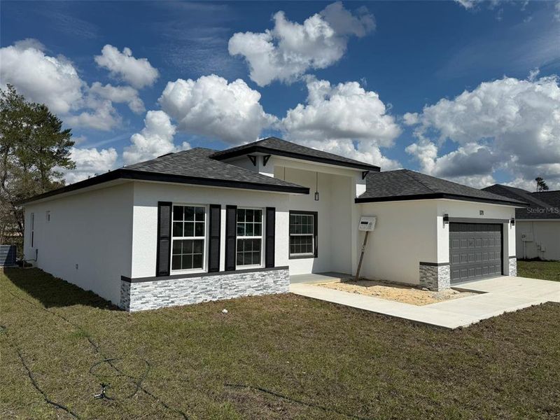 Front exterior of a new home in , Ocala, FL, highlighting curb appeal (Image 1).