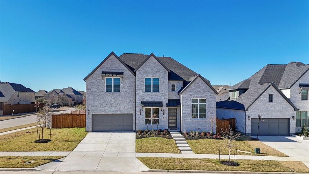 Front exterior of a new home in Estates at Rockhill, Frisco, TX, highlighting curb appeal (Image 1). Front exterior of a new home in Estates at Rockhill, Frisco, TX, highlighting curb appeal (Image 1).