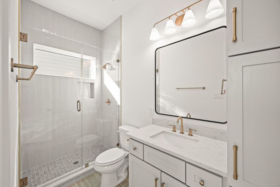 The bathroom offers natural light and a walk-in shower!