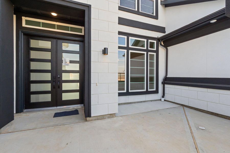Representative example of how the home will look. A beautiful elevation rendered in black and white stucco.