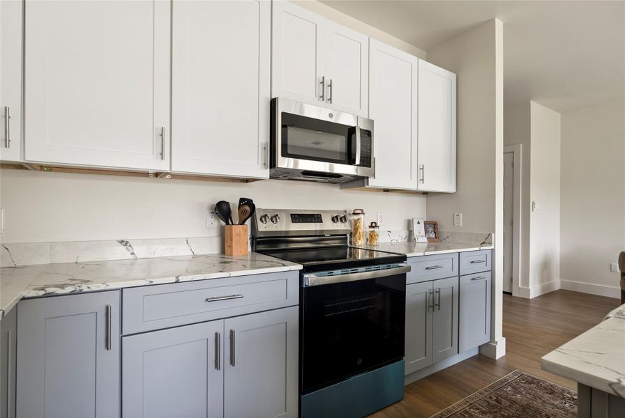 Culinary delights await in this modern kitchen with sleek cabinetry and elegant stone countertops.