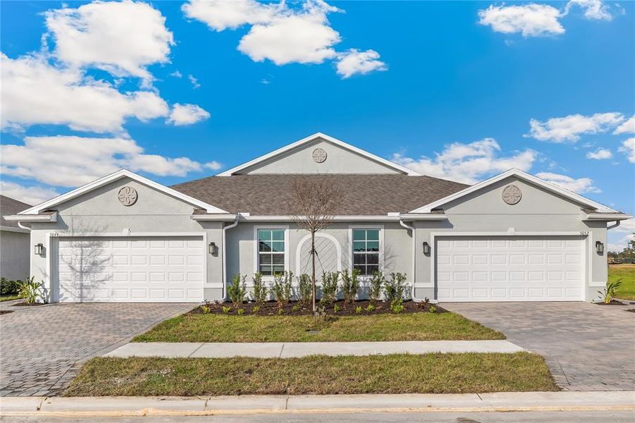 Front exterior of a new home in Central Parc, North Port, FL, highlighting curb appeal (Image 2). Front exterior of a new home in Central Parc, North Port, FL, highlighting curb appeal (Image 2).