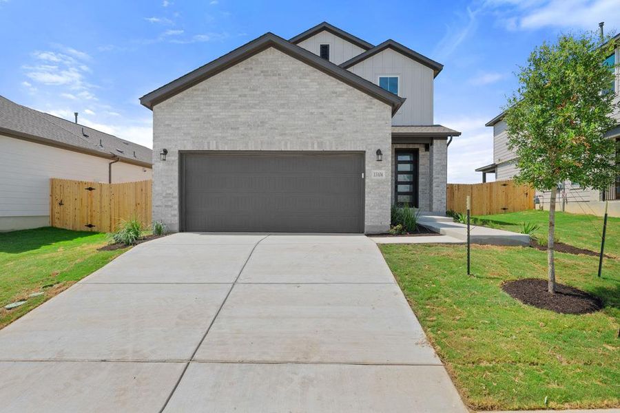 Front exterior of a new home in Terrace Collection At Turner's Crossing, Buda, TX, highlighting curb appeal (Image 2). Front exterior of a new home in Terrace Collection At Turner's Crossing, Buda, TX, highlighting curb appeal (Image 2).