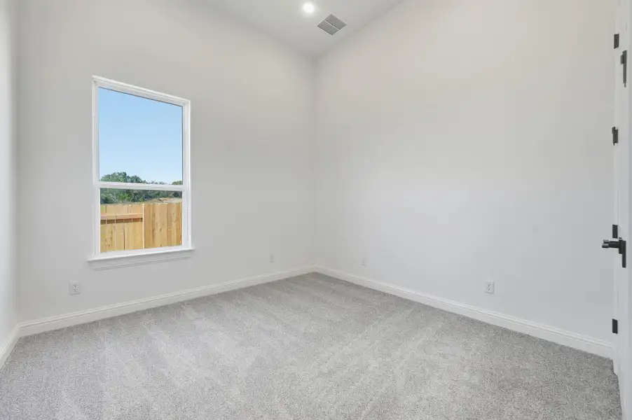 Empty room featuring light carpet and recessed lighting