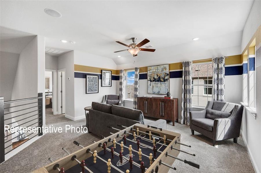 Living room with light colored carpet and ceiling fan