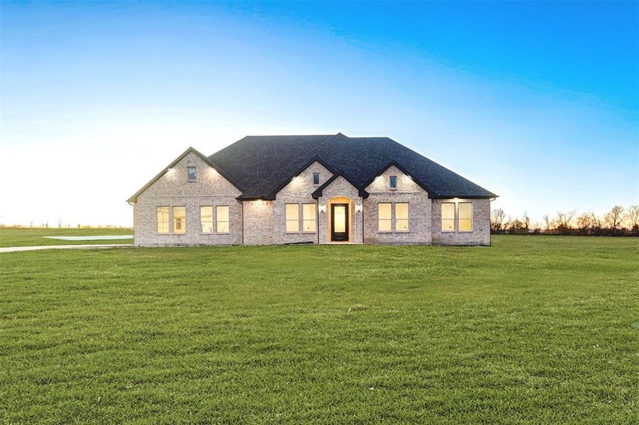 French provincial home with a front yard