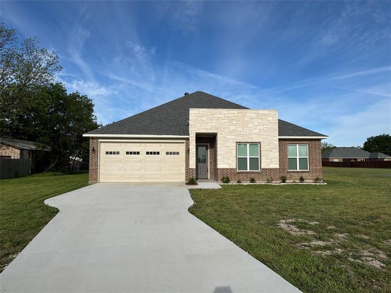 Front exterior of a new home in , Commerce, TX, highlighting curb appeal (Image 21).