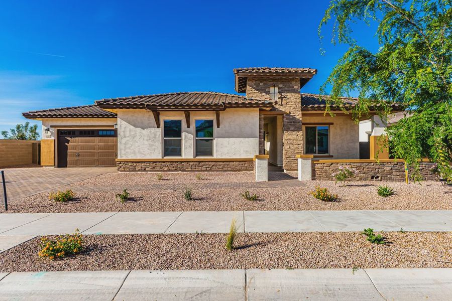 Front exterior of a new home in Bellero Estates, Queen Creek, AZ, highlighting curb appeal (Image 2). Front exterior of a new home in Bellero Estates, Queen Creek, AZ, highlighting curb appeal (Image 2).