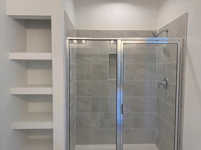 Primary Bath featuring the AW Collection® Coastal - Spa-like with white cabinets and light tile.