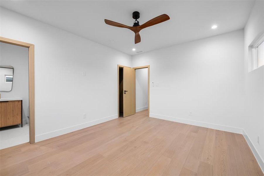 Empty room featuring light wood-type flooring, recessed lighting, and a ceiling fan