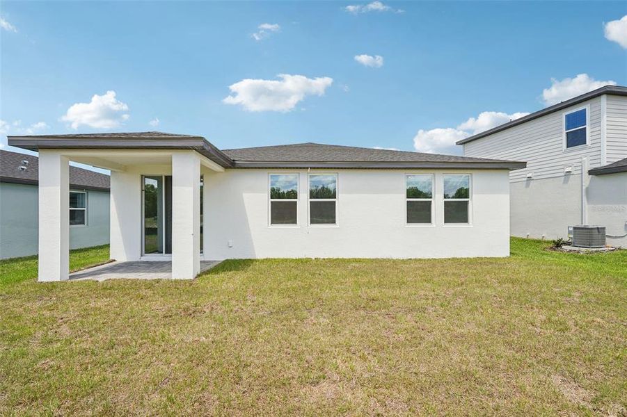 Exterior details and patio area of a home in The Reserve at Hammock Oaks - Signature Series, Lady Lake (Image 4).