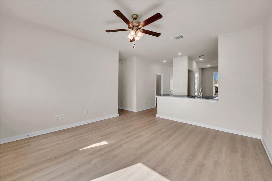Unfurnished living room with recessed lighting, a ceiling fan, and light wood-style flooring