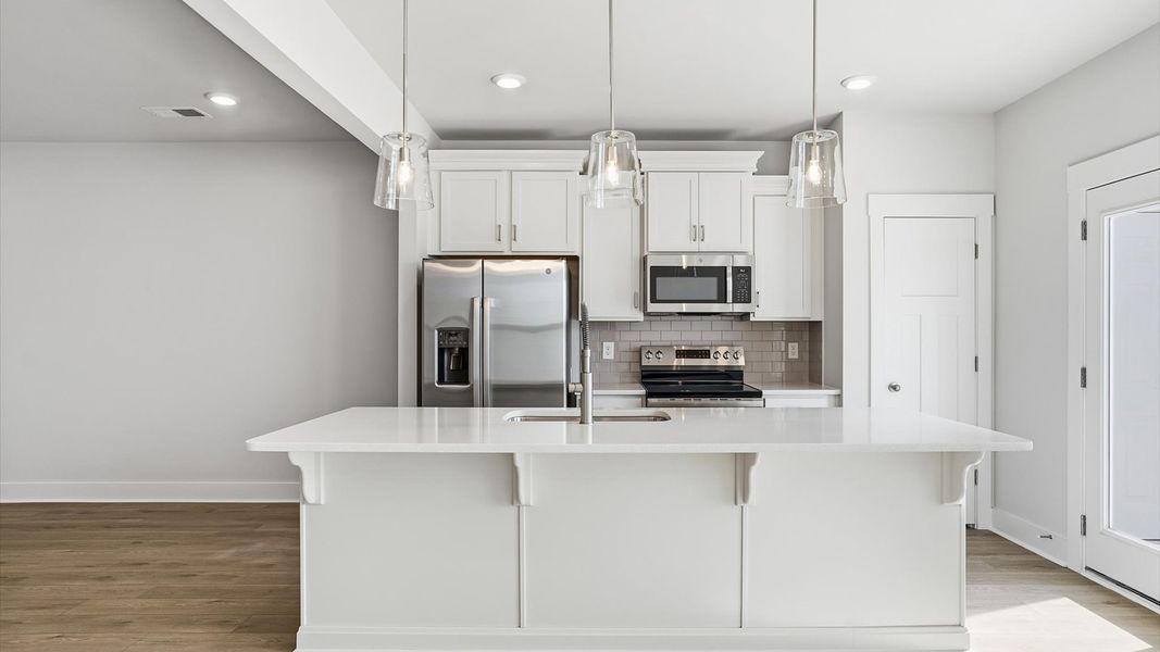Well-designed kitchen with a center island and tasteful finishes that elevate everyday living at Gresham Station