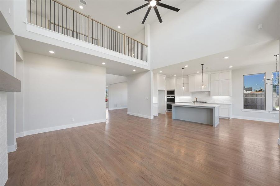 Unfurnished living room with recessed lighting, light wood-style floors, and a ceiling fan Unfurnished living room with recessed lighting, light wood-style floors, and a ceiling fan