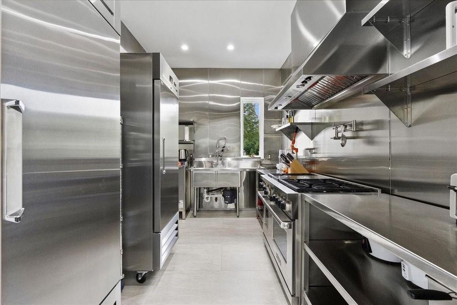 This is an absolute rarity in residential real estate! Fully equipped commercial kitchen featuring a dual gas and electric WOLF range.