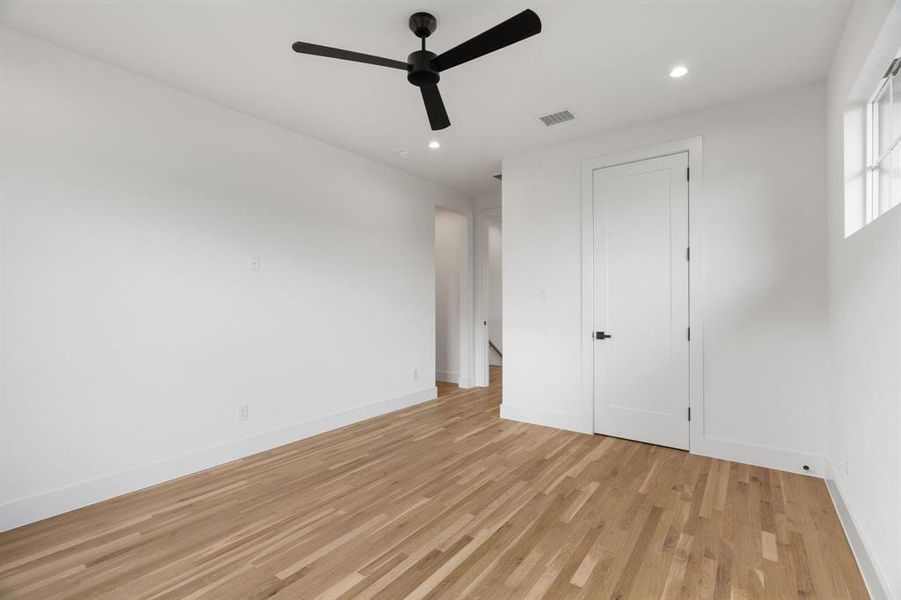 Unfurnished bedroom with light wood-style flooring, recessed lighting, and a ceiling fan Unfurnished bedroom with light wood-style flooring, recessed lighting, and a ceiling fan