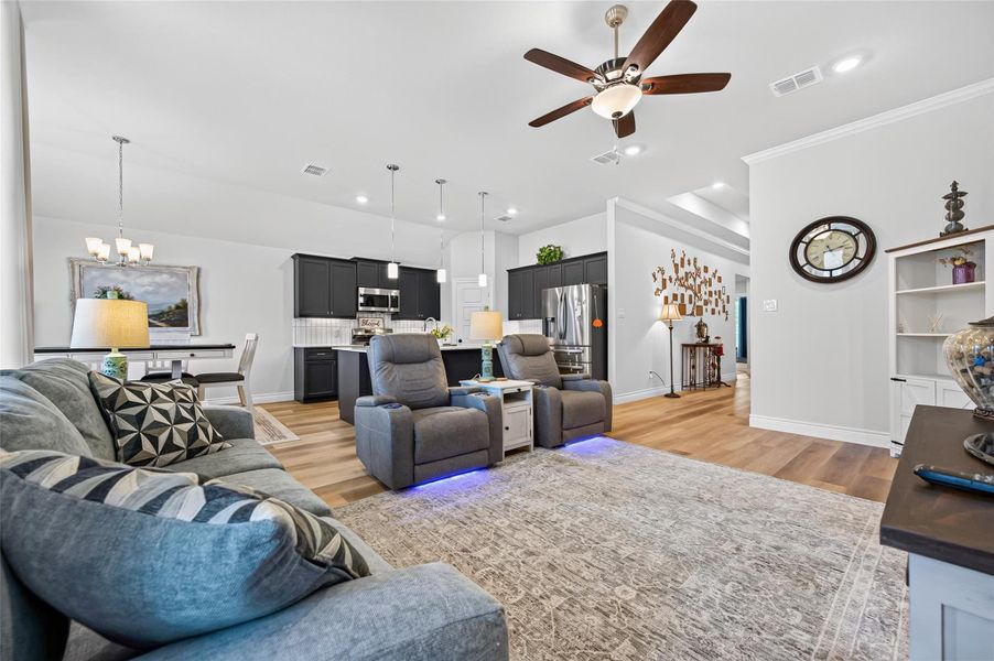 This expansive living area is defined by its impressive soaring ceilings and sophisticated crown molding, creating a bright and airy atmosphere that serves as the heart of the home. The space transitions seamlessly into a gourmet-inspired kitchen, which has been thoughtfully updated with high-end stainless steel appliances, premium fixtures, and a layout designed to accommodate both casual daily living and elegant formal entertaining. This expansive living area is defined by its impressive soaring ceilings and sophisticated crown molding, creating a bright and airy atmosphere that serves as the heart of the home. The space transitions seamlessly into a gourmet-inspired kitchen, which has been thoughtfully updated with high-end stainless steel appliances, premium fixtures, and a layout designed to accommodate both casual daily living and elegant formal entertaining.