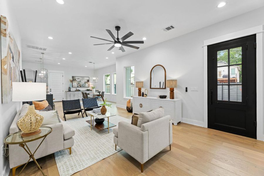 Living room with high ceilings, modern ceiling fan and recessed lighting. Living room with high ceilings, modern ceiling fan and recessed lighting.