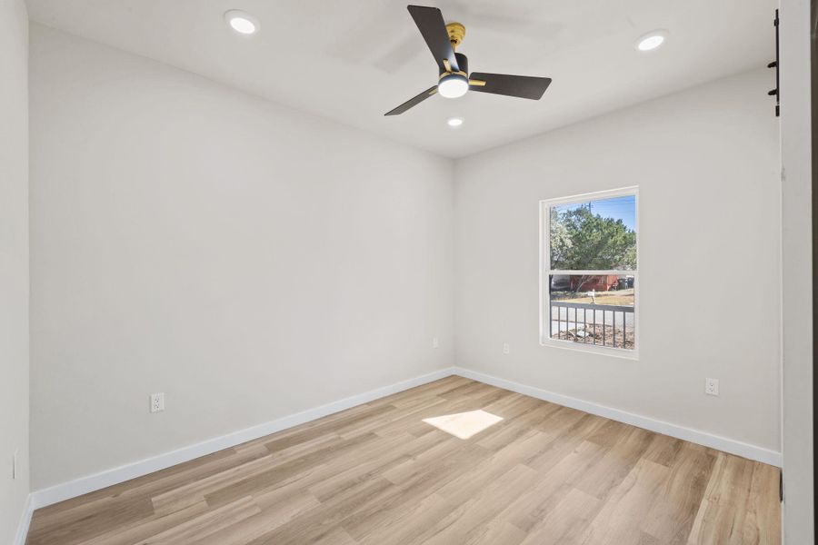 Empty room with light wood-type flooring, recessed lighting, and a ceiling fan Empty room with light wood-type flooring, recessed lighting, and a ceiling fan