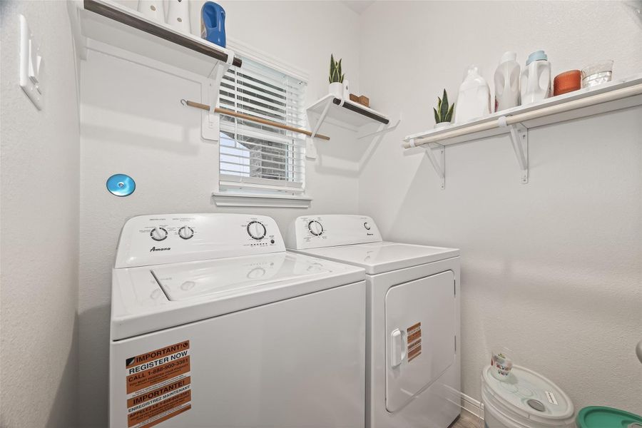 This isn't just a utility room; with a bright window and built-in storage, it's a functional space that actually feels good to be in.