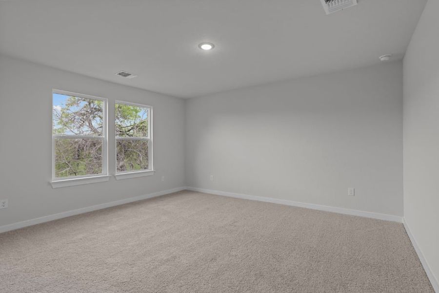 A room with windows and a carpet.