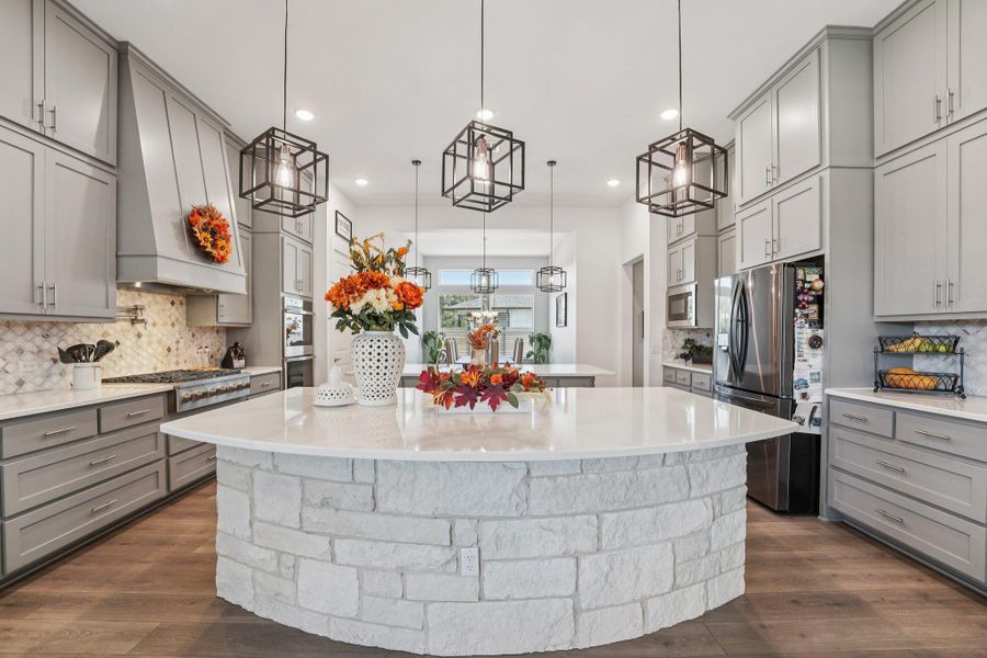 A chef’s dream kitchen with double islands, quartz countertops, and a bright, functional layout designed for entertaining.