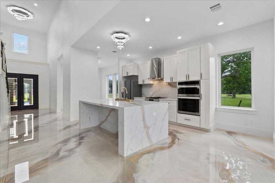 Designer kitchen with double ovens and modern cabinetry.