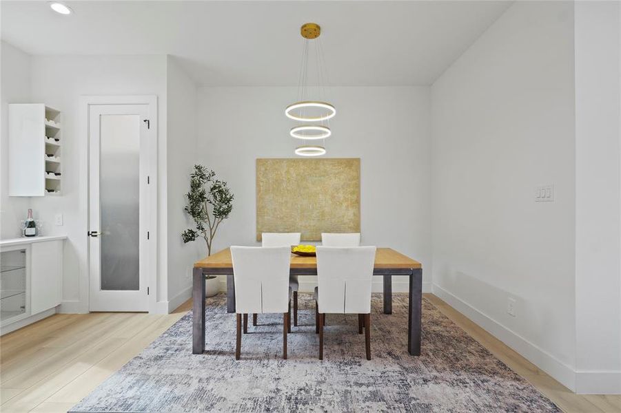 Dining area featuring light wood-type flooring Dining area featuring light wood-type flooring