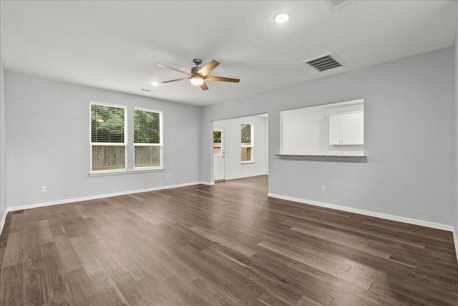 Beyond the entry is the open living room with a view of the dinind and into the kitchen.