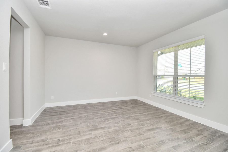 Make memories gathered around the table with your family and friends! This spacious dining room features elegant flooring, custom paint, and adjacent to family room and kitchen for open concept feel. Sample photo of completed home with similar floor plan. Actual colors and selections may vary.