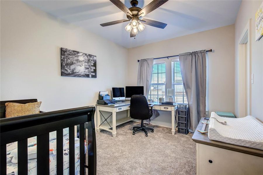 Carpeted bedroom with ceiling fan