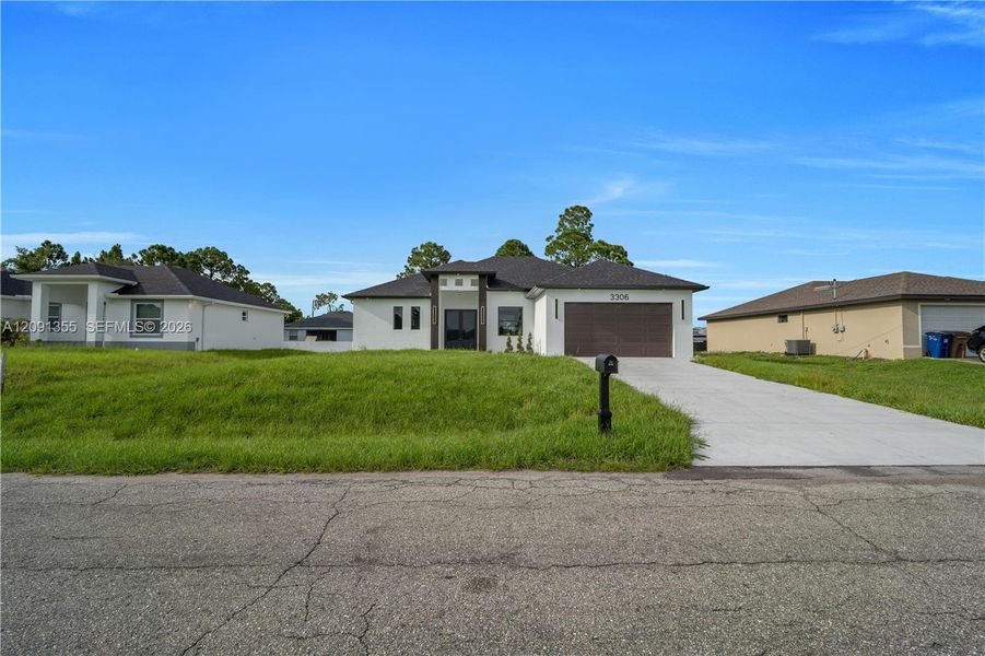 Front exterior of a new home in , Lehigh Acres, FL, highlighting curb appeal (Image 2). Front exterior of a new home in , Lehigh Acres, FL, highlighting curb appeal (Image 2).