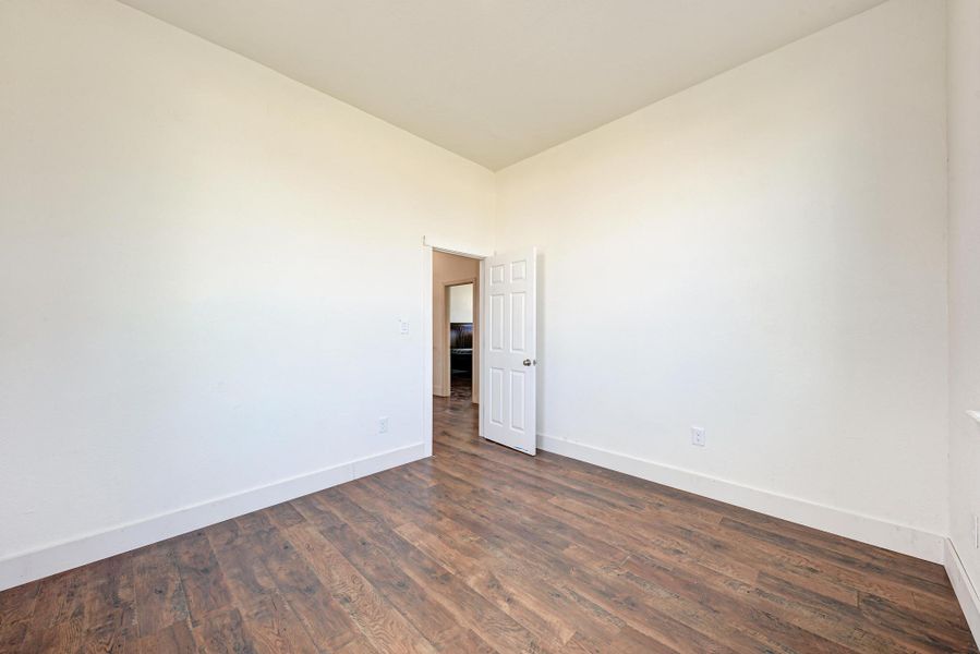 Rich wood floors lay a warm foundation below clean white walls and high ceilings.